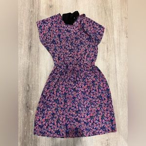 Fun and lightweight dress with a unique leaf print and bow tie closure in back.